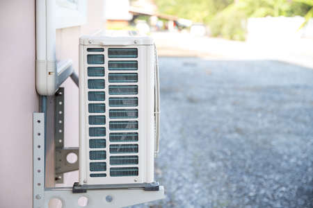 External split wall type of house air conditioner compressor unit installed on the outside of the building.の写真素材