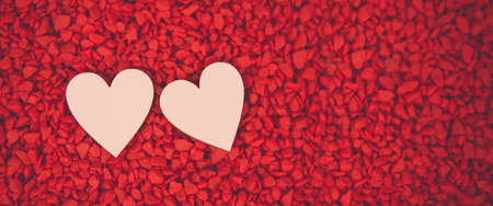 Close-up two hearts for love symbol on a red sand background. Concept the day of love 14 February happy valentine's day.の写真素材