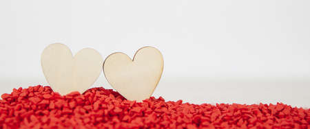 Close-up two hearts for love symbol on a red sand background. Concept the day of love 14 February happy valentine's day.の写真素材