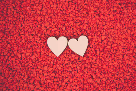 Close-up two hearts for love symbol on a red sand background. Concept the day of love 14 February happy valentine's day.の写真素材