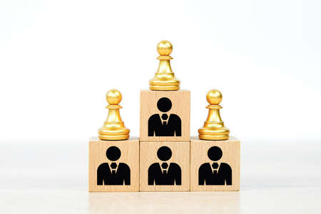 Person individual people icons and chess on wooden toy blocks stacked in pyramid. Concepts of human resources for business organization and leadership.の写真素材