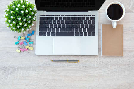 Top view desk and computer tablet or laptop with a pen and office equipment for working area copy...