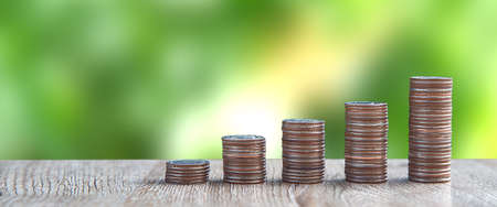 Pile of coins is stacked in a graph shape for money saving ideas and financial planning insurance.の写真素材