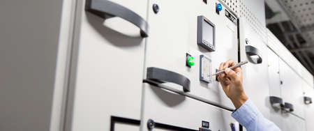 Close-up hand of electrical engineering using measuring equipment tool to checking electricity at...