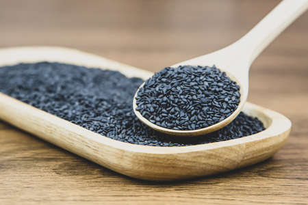 Black sesame seeds in a wooden spoon For healthy food and diet concepts.の写真素材