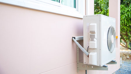 External split wall type of house air conditioner compressor unit installed on the outside of the building.の写真素材