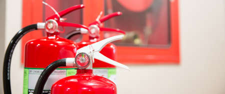 Fire extinguisher tank with exit door in the building concepts of protection and prevent for emergency and safety rescue and fire training.の写真素材