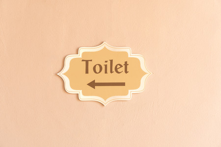 Direction sign for toilet with male and female sign. on cement backgroundの写真素材