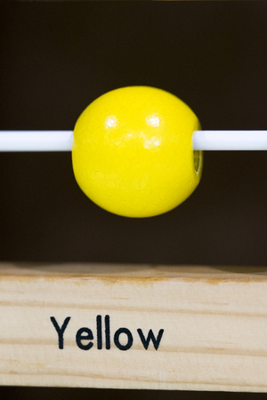 Yellow color Wooden toy to learn and play with shapes and color (selective focus)の写真素材
