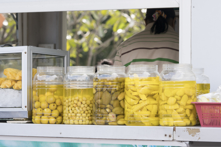 Preserved food -Jars with variety of pickled fruit shop in Thailandの写真素材