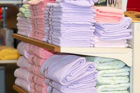 Stack of the multicolored towels on shelfの写真素材