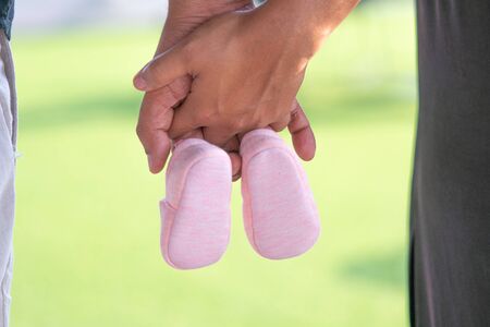 Farther and mother holding Small shoes for the unborn babyの写真素材