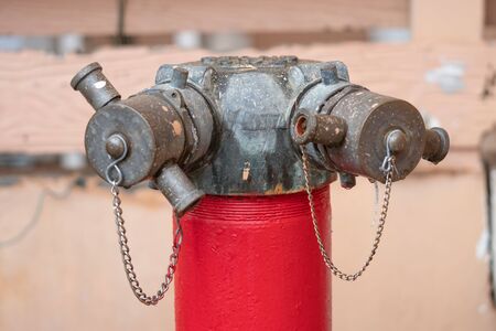 Red fire hydrant water pipe with a chain on the streetの写真素材