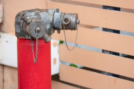 Red fire hydrant water pipe with a chain on the streetの写真素材