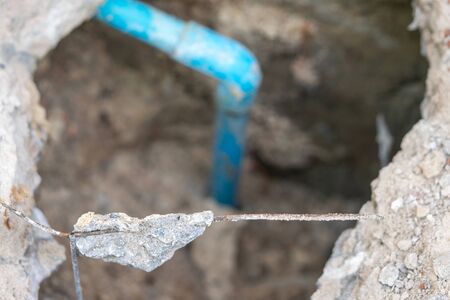 leaking water from blue pipe from undergroundの写真素材