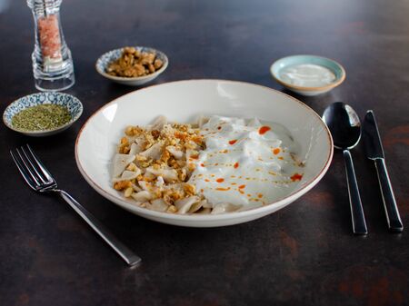 Perfect Turkish Ravioli and Chili Peppers Fried in Butter. Homemade delicious turkish manti ( turkish ravioli ) with yogurt and sauce. stock photoの写真素材