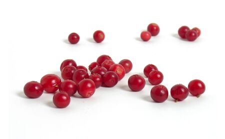 Scattering of cranberries on white background                              