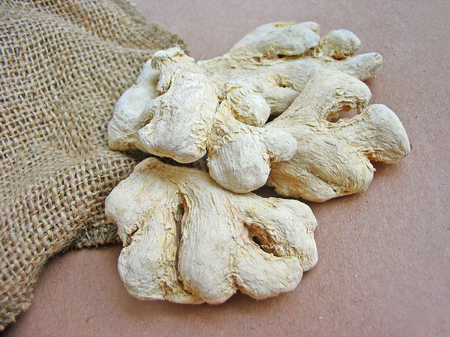 Ginger roots on brown backgroundの写真素材
