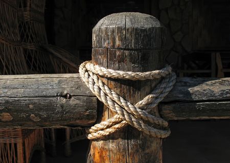 Wooden fence and rope on black backgroundの写真素材