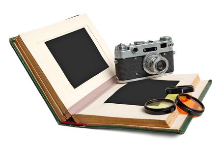 Old photo album with empty pictures and vintage camera with photofiltersの写真素材