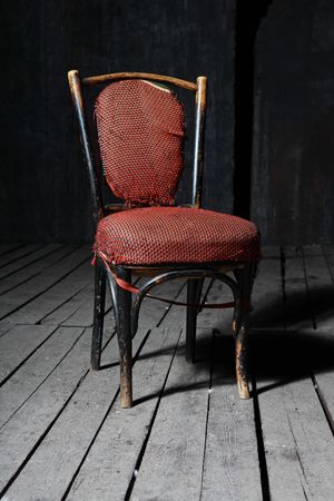 Old fashioned chair on wooden floorの写真素材