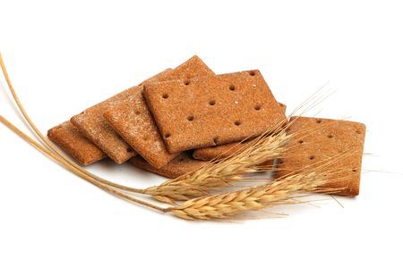 Stack of cracker slices for balance diet and wheat on white backgroundの写真素材