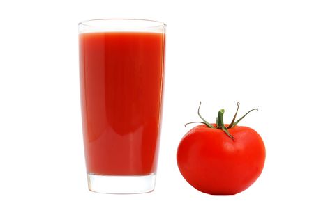 Fresh tomatoes and a glass full of tomato juice.の写真素材