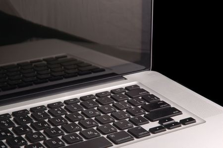 Aluminium laptop with desktop on black backgroundの写真素材