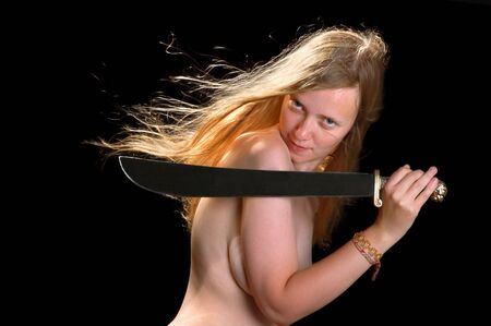 Beautiful red hair girl with a sword on a black backgroundの写真素材