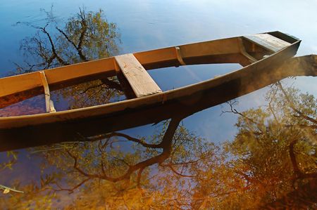Beautiful autumn river and yellow rowing boat on a tranquil early morning