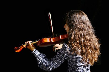 Beautiful violinist musician on black backgroundの写真素材