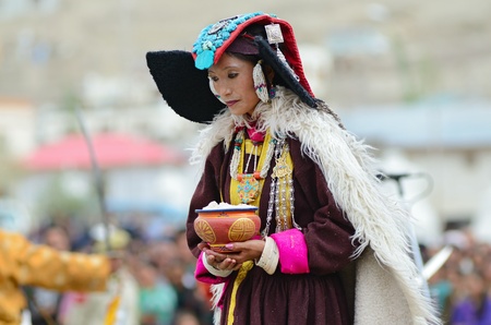 LEH, LADAKH, INDIA - SEPTEMBER 08, 2012: Woman in traditional tibetan costumes performing folk dance. Last day of Annual Festival of Ladakh Heritage in Leh, India. September 08, 2012.のeditorial素材