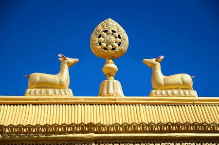 Wheel of Dharma and golden deers on a top of Tibetan monastery gates in India, Ladakh.の写真素材