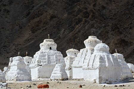 Buddhist chortens (stupa) and Himalayas mountains on the background in valley near Leh, Ladakh, Indiaの写真素材