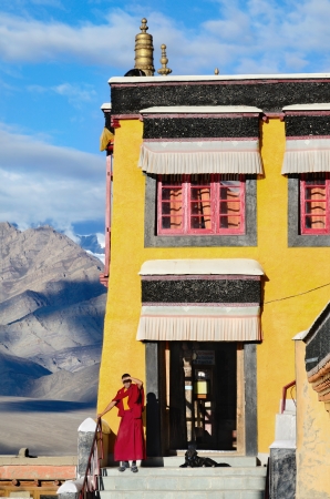 LADAKH, INDIA - SEPTEMBER 13, 2012: Buddhist Monk with dog in tibetan monastery Thiksey Gompa in Ladakh, India. September 13, 2012.のeditorial素材