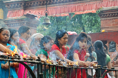 Kathmandu, Nepal - September 18, 2012: Hindu women in traditional red sari celebrating the Haritalika Teej festival on Durbar square in Kathmandu, Nepalのeditorial素材