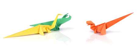 Colored origami paper dinosaurus over white backgroundの写真素材