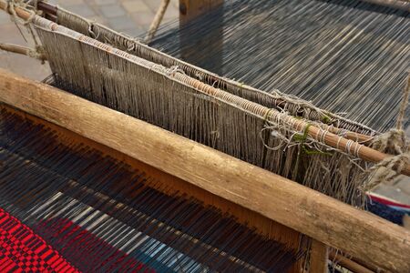 Part of traditional vintage belorussian weaving hand loom with wool close up