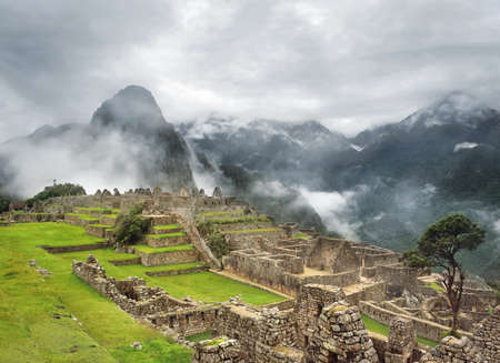 View of the Machu Picchu Inca citadel with Huayna Picchu at the background.