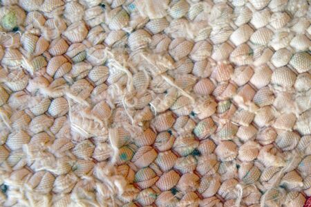 The weave multicolored threads of fabric closeup