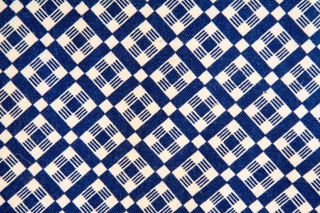 The texture of the white and blue fabric in a cage