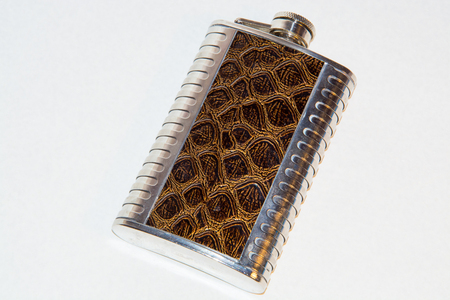 metal flask with leather trim on a white backgroundの写真素材