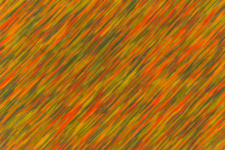 Texture of mottled fabric with orange and green touchesの写真素材