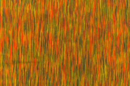 Texture of mottled fabric with orange and green touchesの写真素材