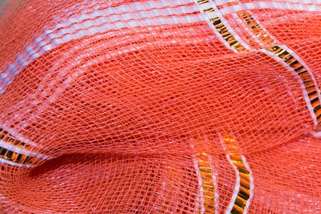 background, texture of red plastic mesh with goldの写真素材