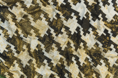 Golden knitted fabric with a pattern of goose foot