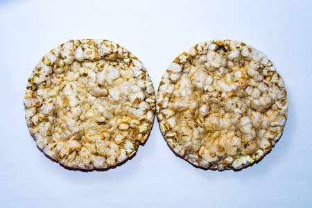 round whole grain crispbread closeup on a white background