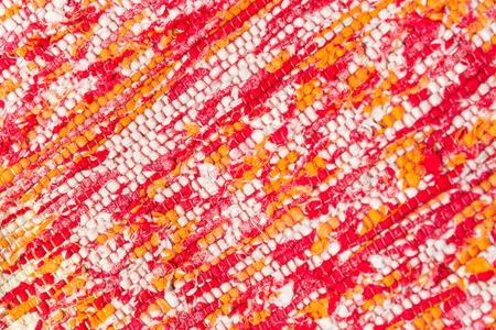 texture of woven cotton threads of red, pink, white, yellow closeup