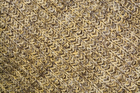 mottled texture of the wool yellow brown knitted fabric closeup