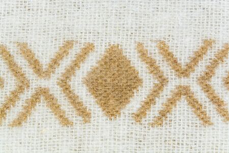 The texture of white woolen yarns twisted with brown ornament closeupの写真素材